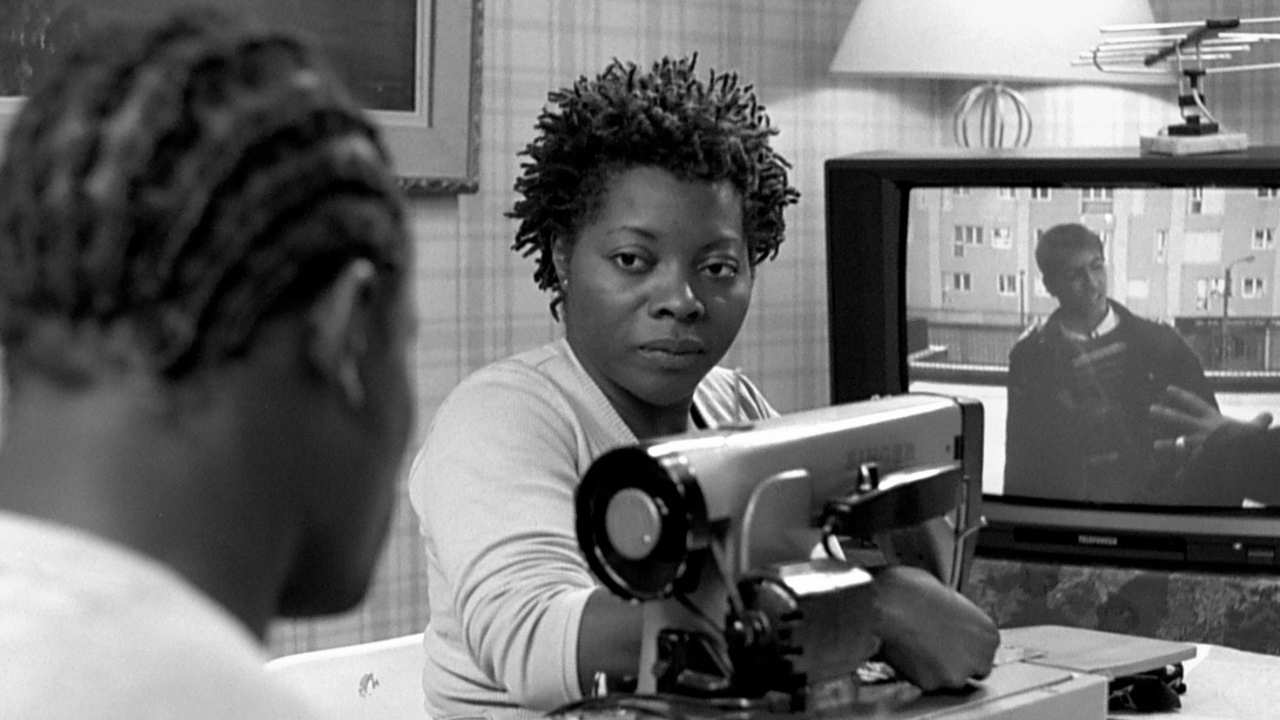 a woman at a sewing machine talking to someone